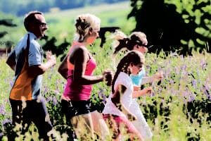 Family running for bettaer fitness in summer through beautiful la