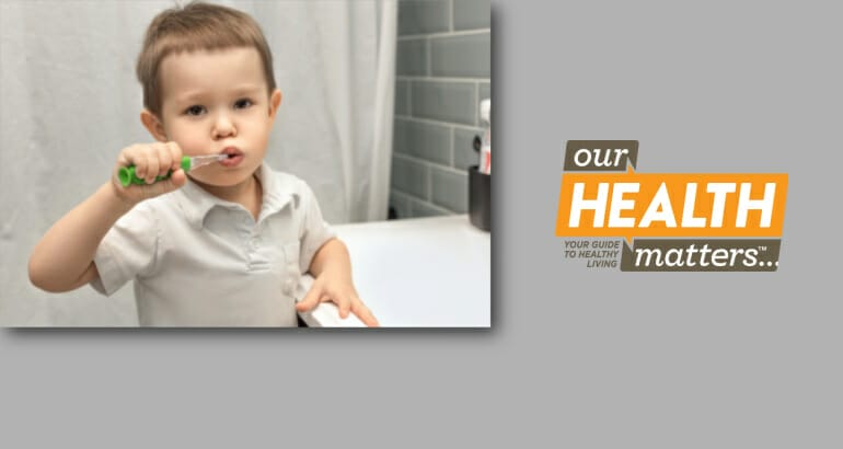 A child brushing their teeth independently